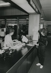 Circulation supervisor Jane Bickford and a female student at the circulation desk