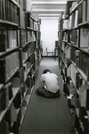 Student reading sitting on the carpet in the library