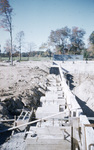Foundation trench for the construction of Alumni Hall looking north toward athletic field