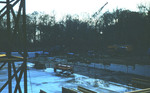Concrete foundation and equipment on the construction site of Alumni Hall at dusk looking west-southwest