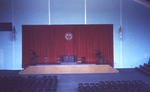 Alternate view of the inside Alumni Hall gym with a view of the stage and podium