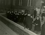 Class of 1951 graduates outside campus building