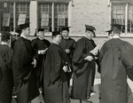 Graduates conversing in line