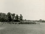 Crowd standing at bandshell on Alumni Field for Commencement 1951