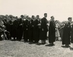 Graduates in line surrounded by guests