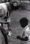 Phil Harris of the New York Giants with a young fan